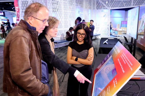 A MADE student and attendees at the Boston's Data Landscapes exhibition